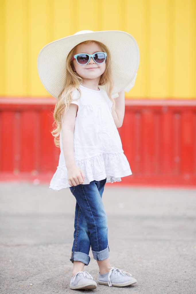 Cute little girl wearing boutique outfit and sun hat | Mama Meg's Boutique
